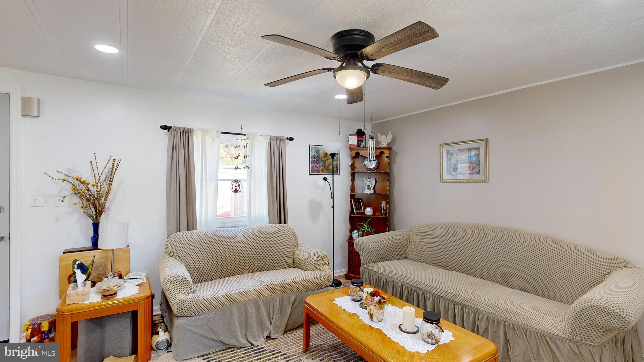 17261 Ridge Line Drive, Unit 18007 Lewes, DE 19958 - Photo 28 of 38 a living room with furniture and a couch