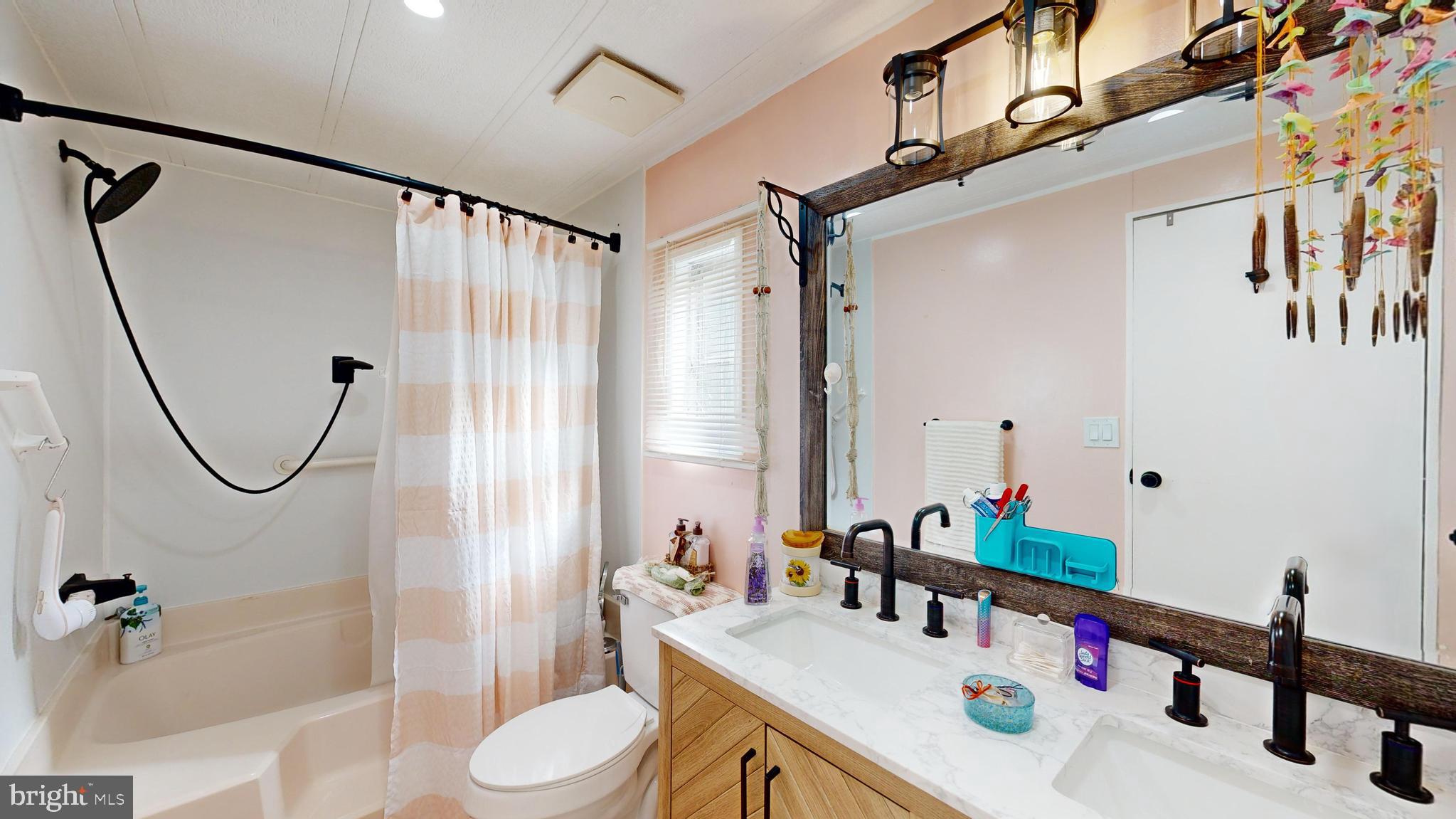 17261 Ridge Line Drive, Unit 18007 Lewes, DE 19958 - Photo 30 of 38 a bathroom with a sink vanity mirror and toilet