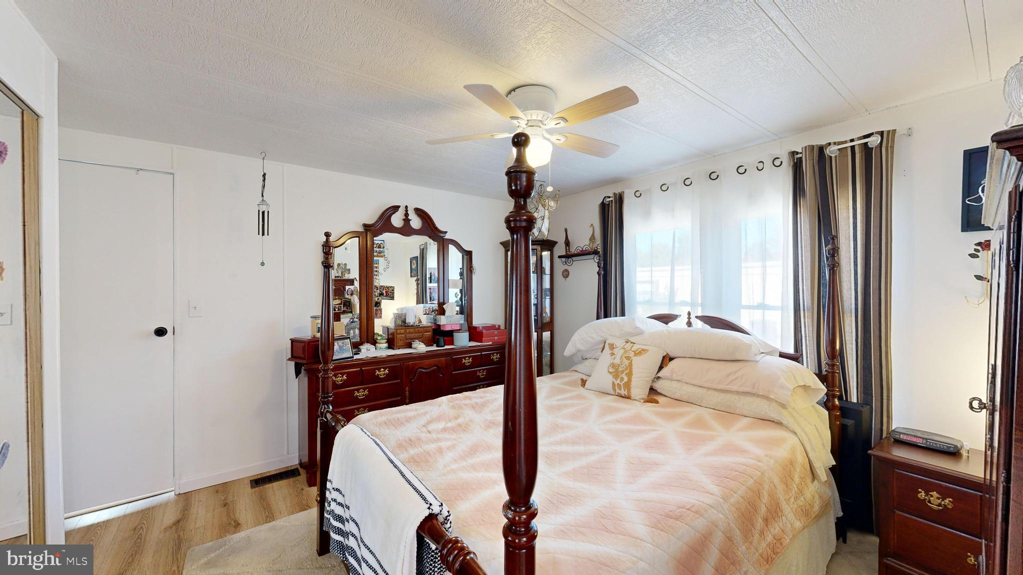 17261 Ridge Line Drive, Unit 18007 Lewes, DE 19958 - Photo 36 of 38 a bedroom with a bed and a chandelier