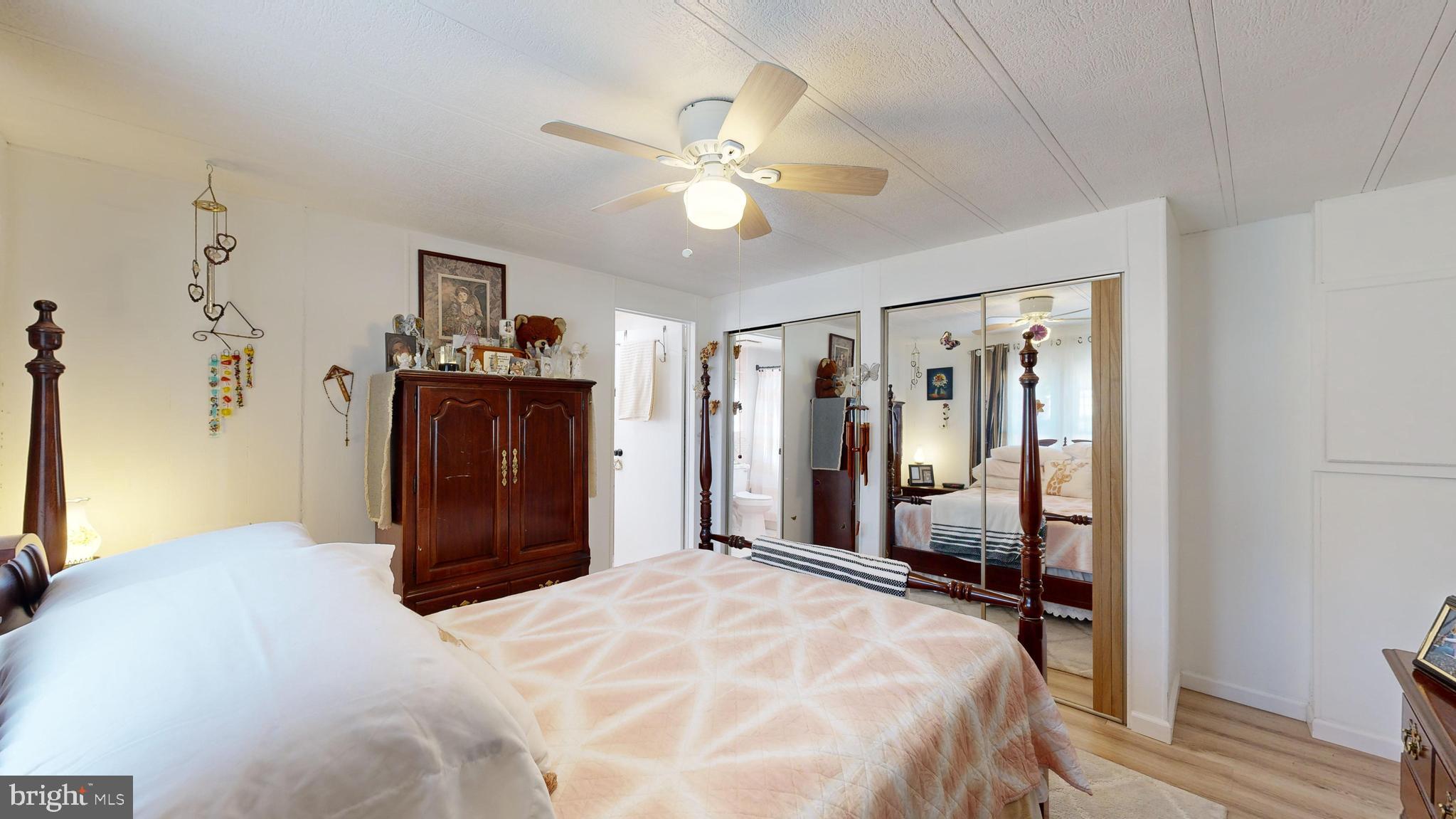 17261 Ridge Line Drive, Unit 18007 Lewes, DE 19958 - Photo 37 of 38 a bedroom with a bed and a chandelier