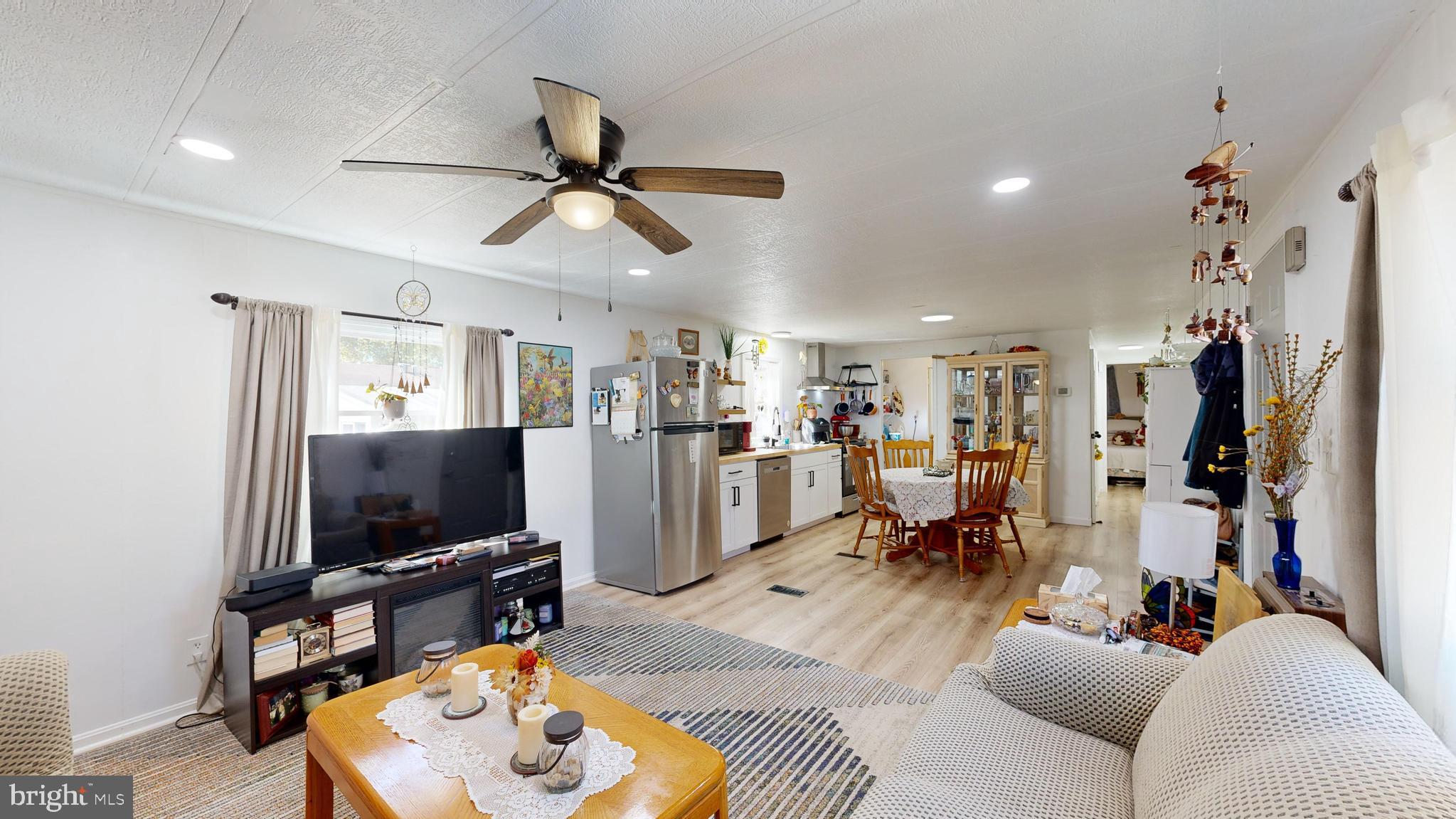 17261 Ridge Line Drive, Unit 18007 Lewes, DE 19958 - Photo 6 of 38 a living room with furniture and a flat screen tv
