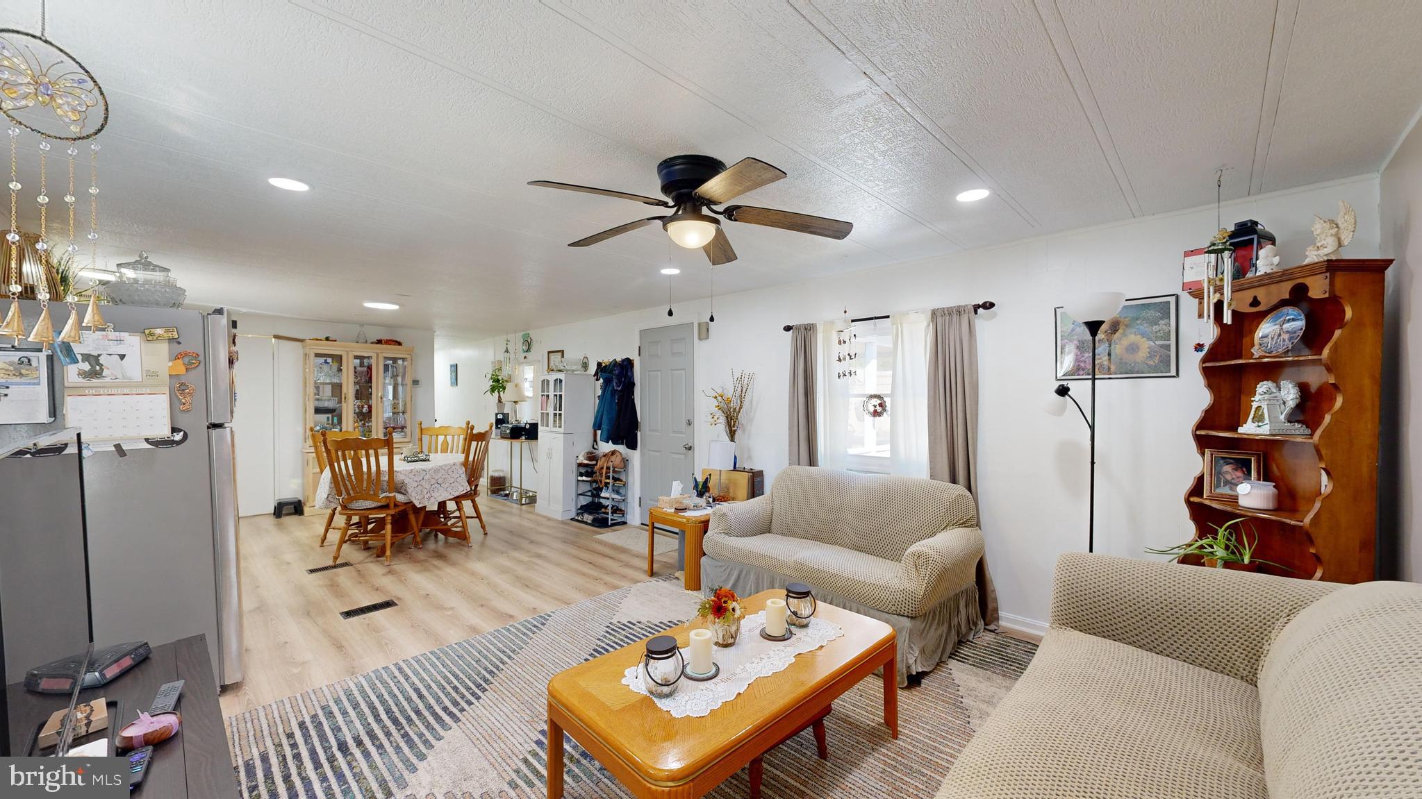 17261 Ridge Line Drive, Unit 18007 Lewes, DE 19958 - Photo 7 of 38 a living room with furniture and kitchen view