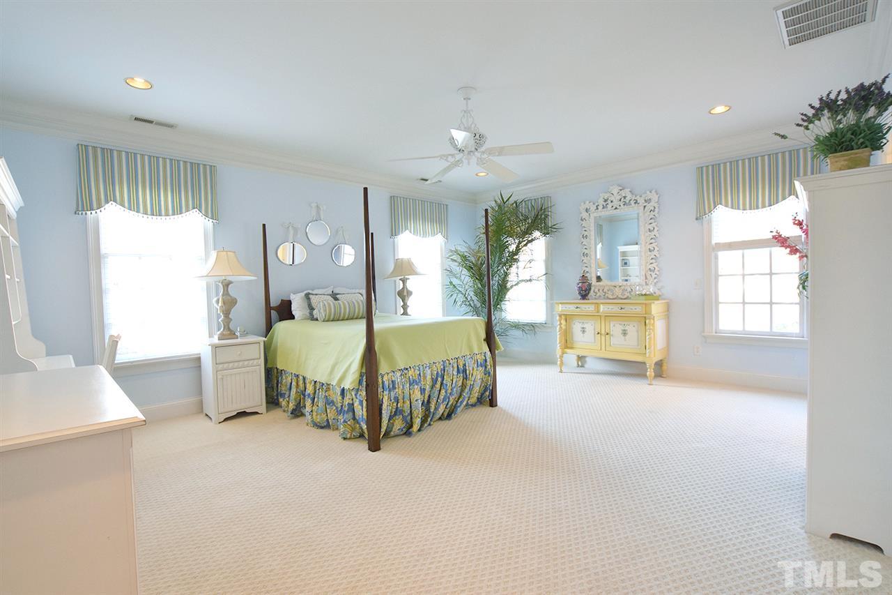 308 Marlowe Road Raleigh, NC 27609 - Photo 18 of 24 a spacious bedroom with a bed couch and window