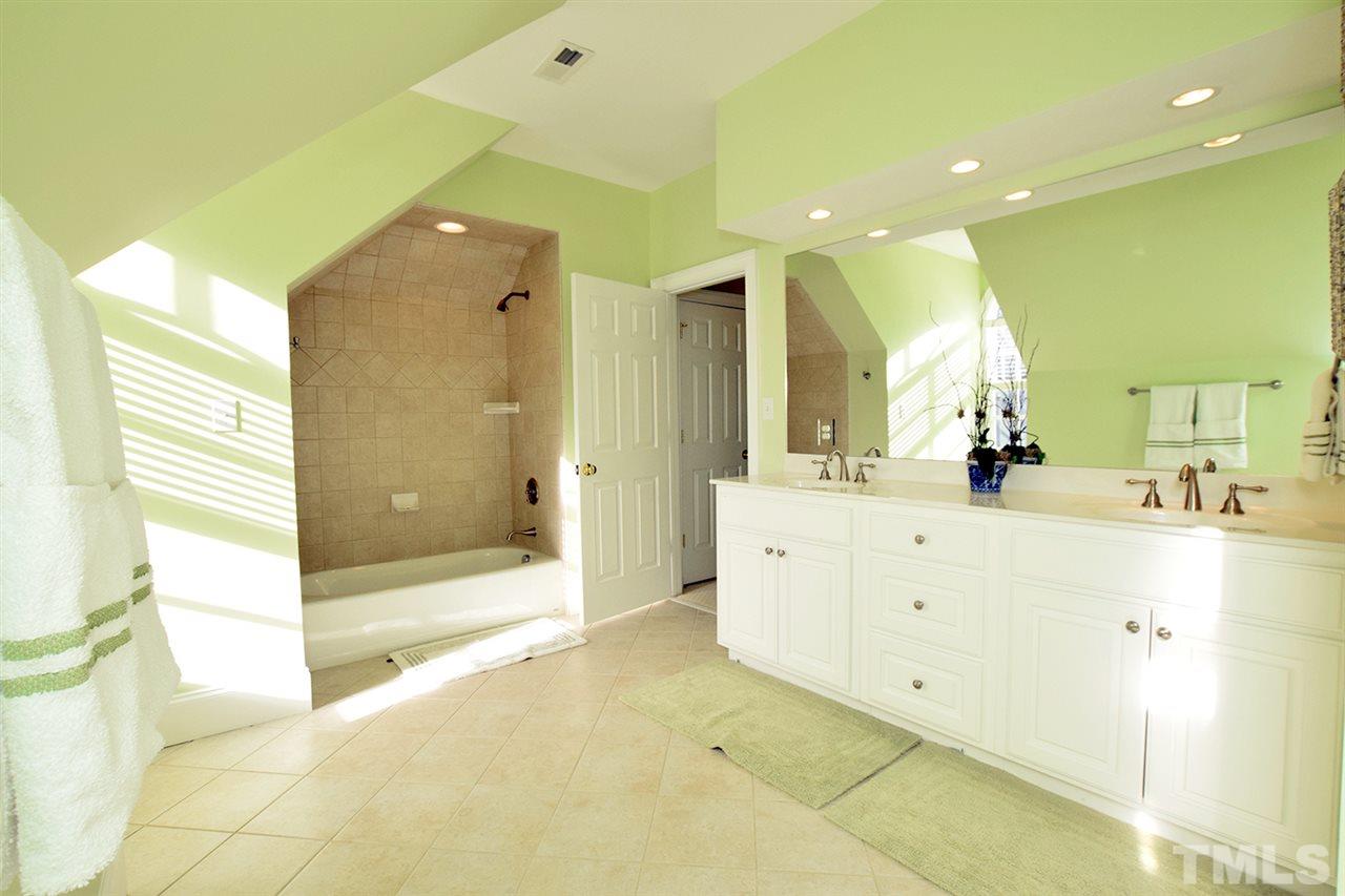 308 Marlowe Road Raleigh, NC 27609 - Photo 19 of 24 a spacious bathroom with a shower a sink and a mirror