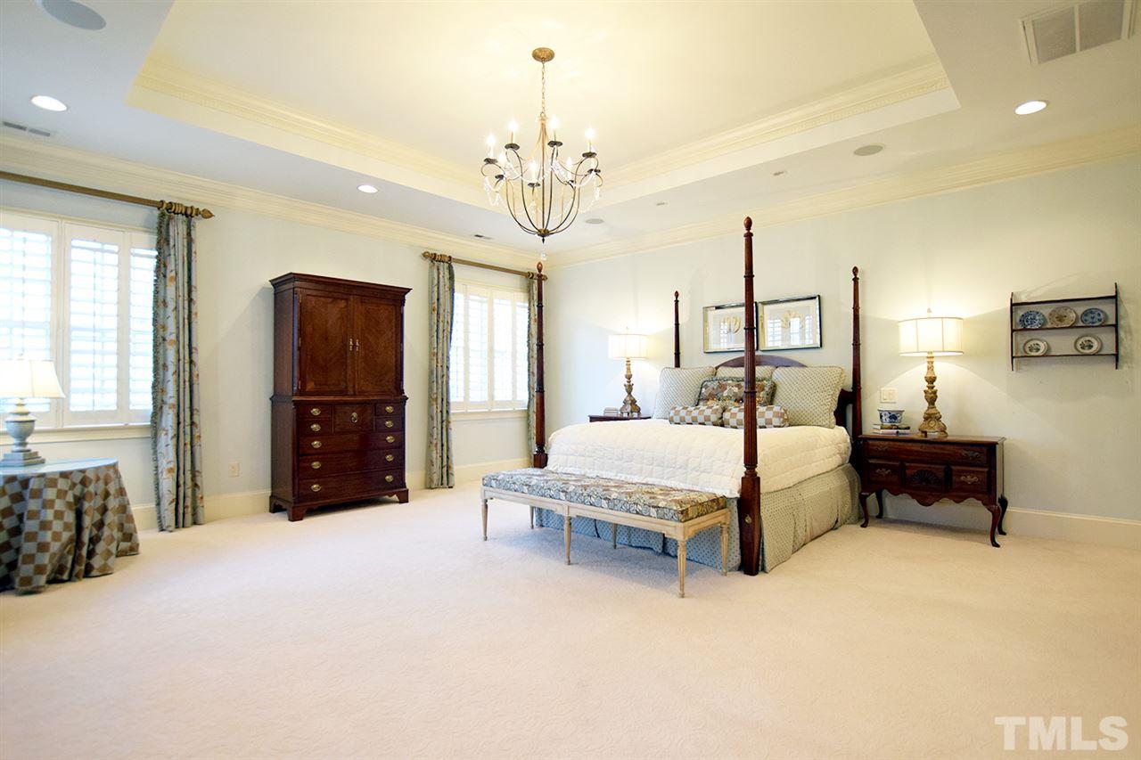 308 Marlowe Road Raleigh, NC 27609 - Photo 10 of 24 a spacious bedroom with a bed chandelier and a window