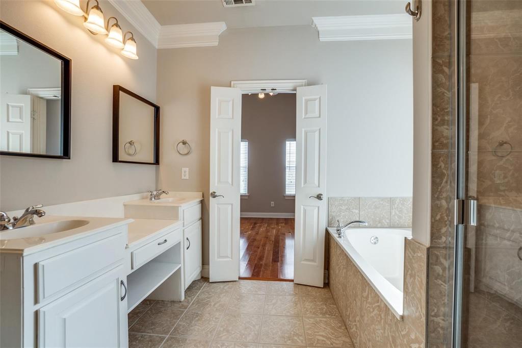 5827 Lewis Street Dallas, TX 75206 - Photo 13 of 24 a bathroom with a tub sink and mirror