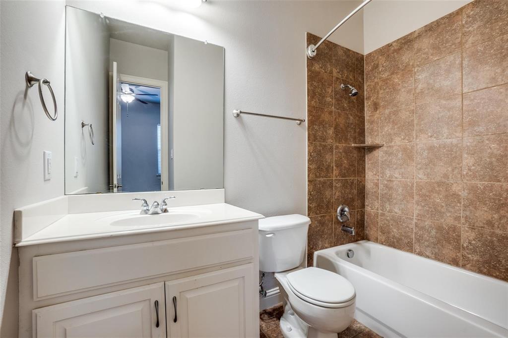 5827 Lewis Street Dallas, TX 75206 - Photo 16 of 24 a bathroom with a sink a toilet and shower