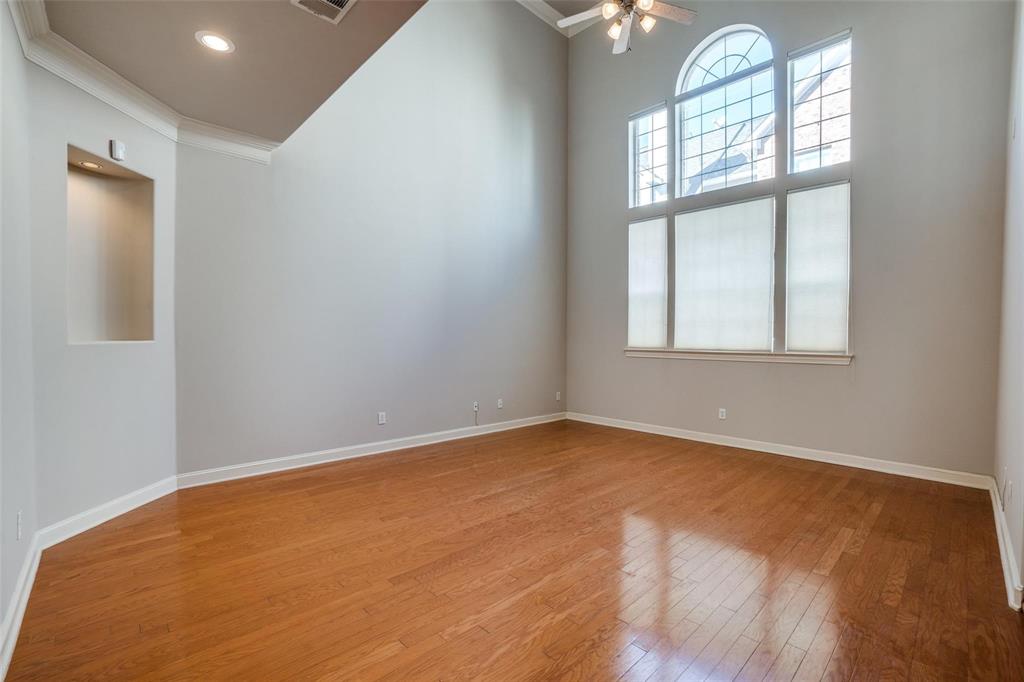 5827 Lewis Street Dallas, TX 75206 - Photo 4 of 24 an empty room with windows and wooden floor