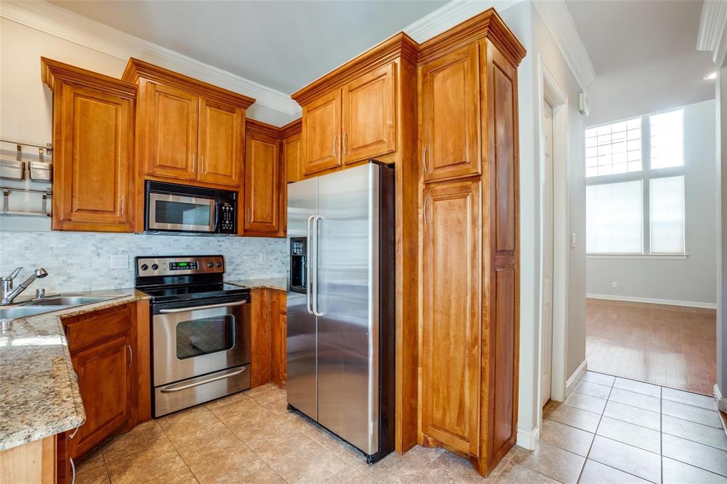 5827 Lewis Street Dallas, TX 75206 - Photo 5 of 24 a kitchen with stainless steel appliances granite countertop a refrigerator and a stove