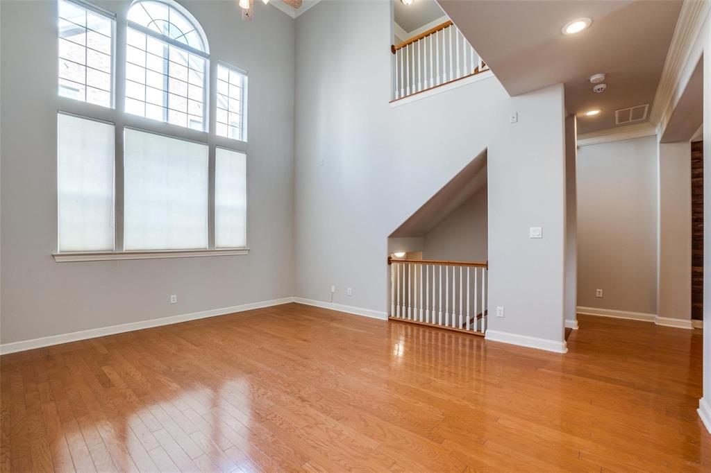 5827 Lewis Street Dallas, TX 75206 - Photo 7 of 24 an empty room with wooden floor and windows