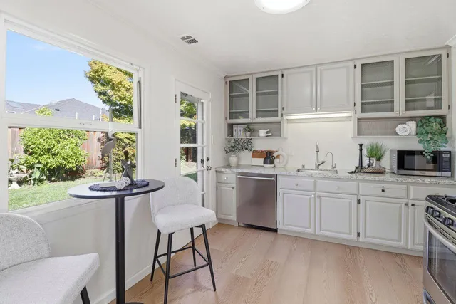 a dining room with furniture and a potted plant