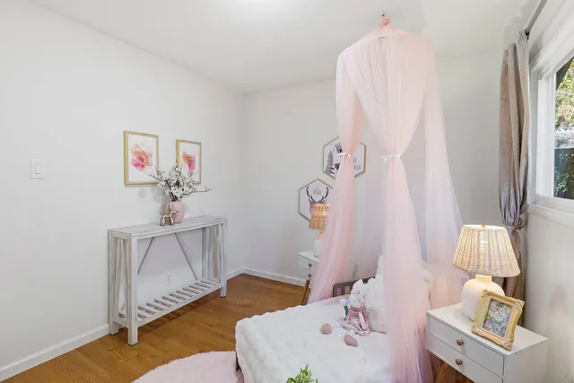 a view of a patio with table and chairs potted plants and large tree