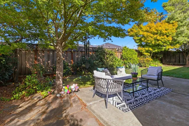 a view of a backyard with sitting area