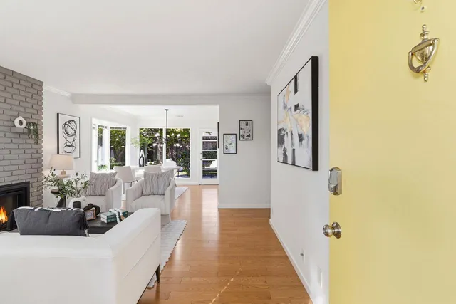 a living room with furniture potted plant and a fireplace