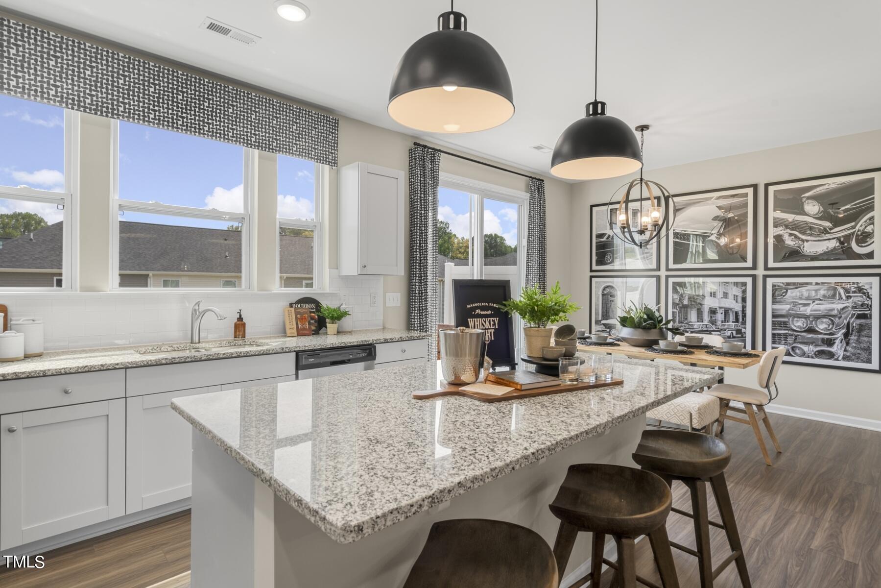 155 Siebold Street Garner, NC 27529 - Photo 27 of 70 a kitchen with granite countertop a sink and a chandelier