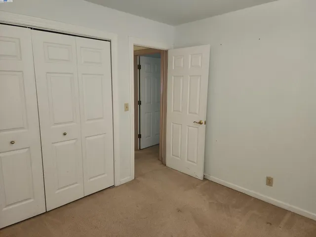 an empty room with closet area