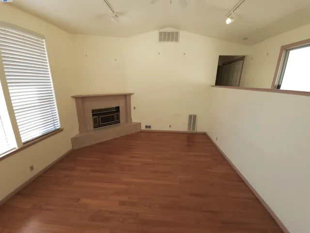 a view of empty room with a fireplace