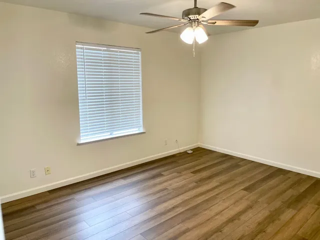 wooden floor in an empty room with a window