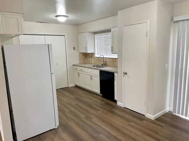 a kitchen with stainless steel appliances a refrigerator and a sink