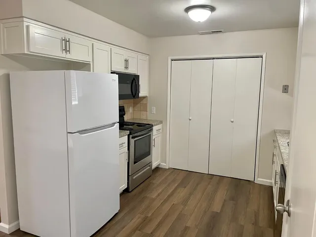 a white refrigerator freezer sitting in a kitchen