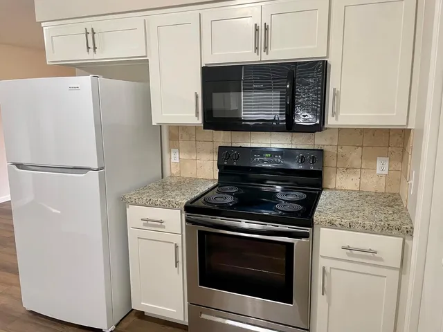a stove top oven sitting inside of a kitchen