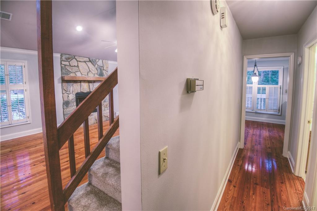 3091 Point Clear Drive Tega Cay, SC 29708 - Photo 13 of 23 a view of a hallway with wooden floor and staircase