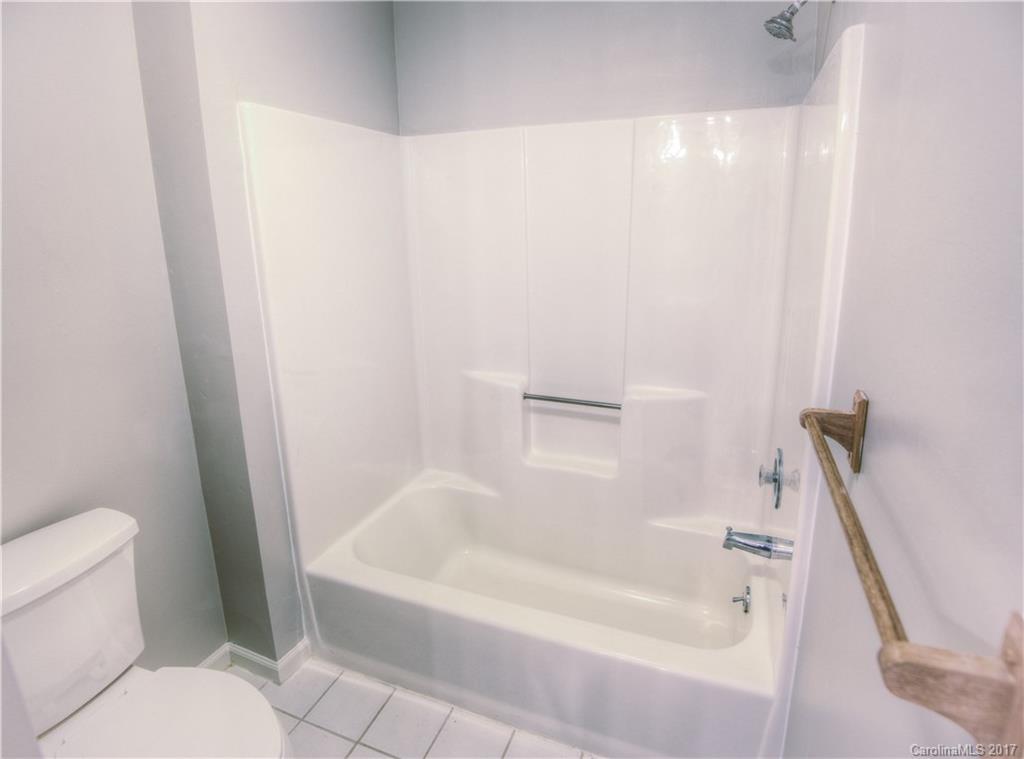 3091 Point Clear Drive Tega Cay, SC 29708 - Photo 18 of 23 a white bath tub sitting next to a white toilet and sink