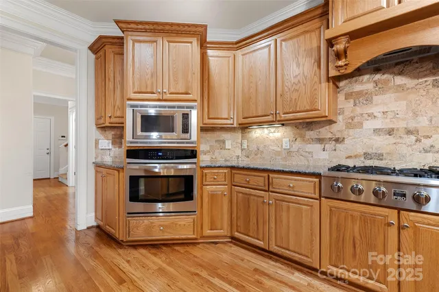 a kitchen with granite countertop a stove and a sink