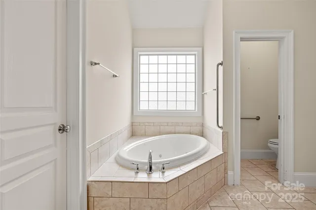 a bathroom with a tub and shower