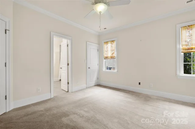 a view of room with window and ceiling fan