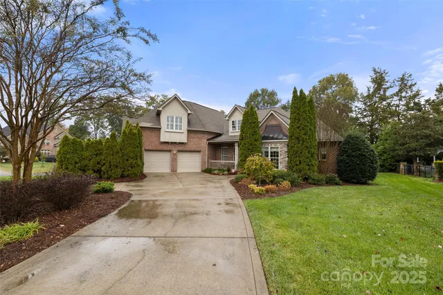 a front view of a house with a yard and trees