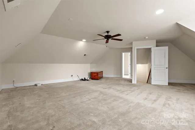 a view of an empty room with a ceiling fan
