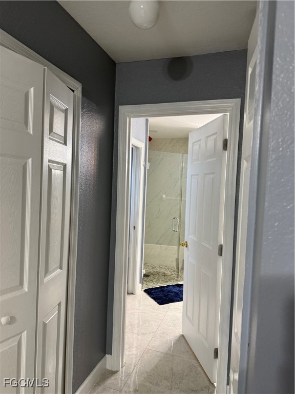 3509 8th Street Southwest Lehigh Acres, FL 33976 - Photo 11 of 14 a view of a bathroom from a hallway