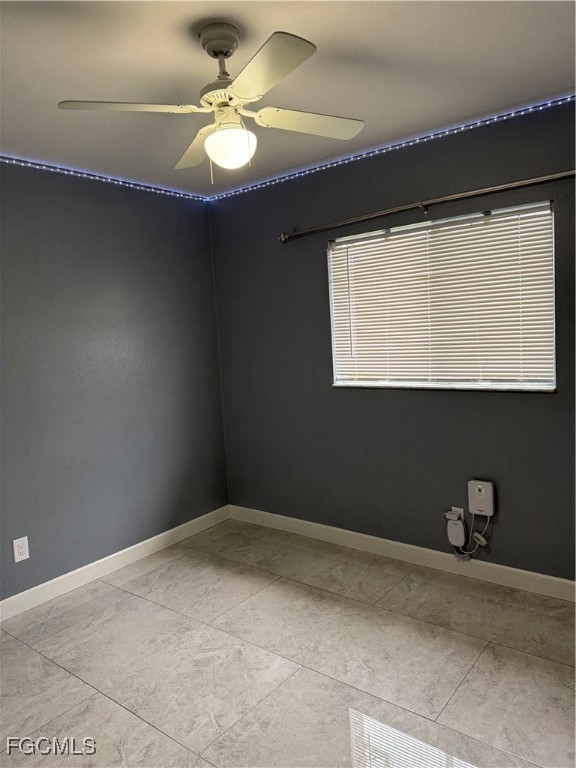 3509 8th Street Southwest Lehigh Acres, FL 33976 - Photo 12 of 14 a view of a small space with a fan and a window