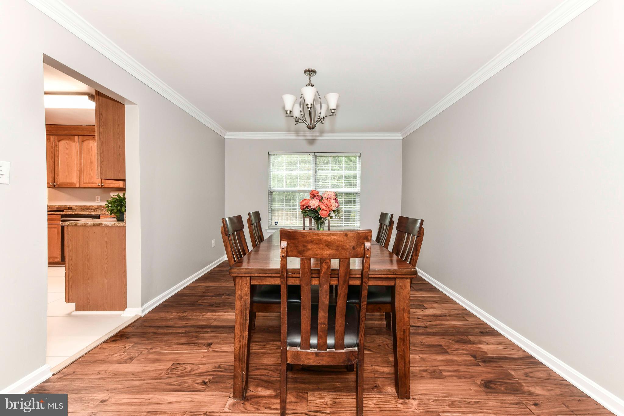 5500 Hampton Forest Way Clifton, VA 20124 - Photo 11 of 49 a view of a dining room with furniture a chandelier and wooden floor