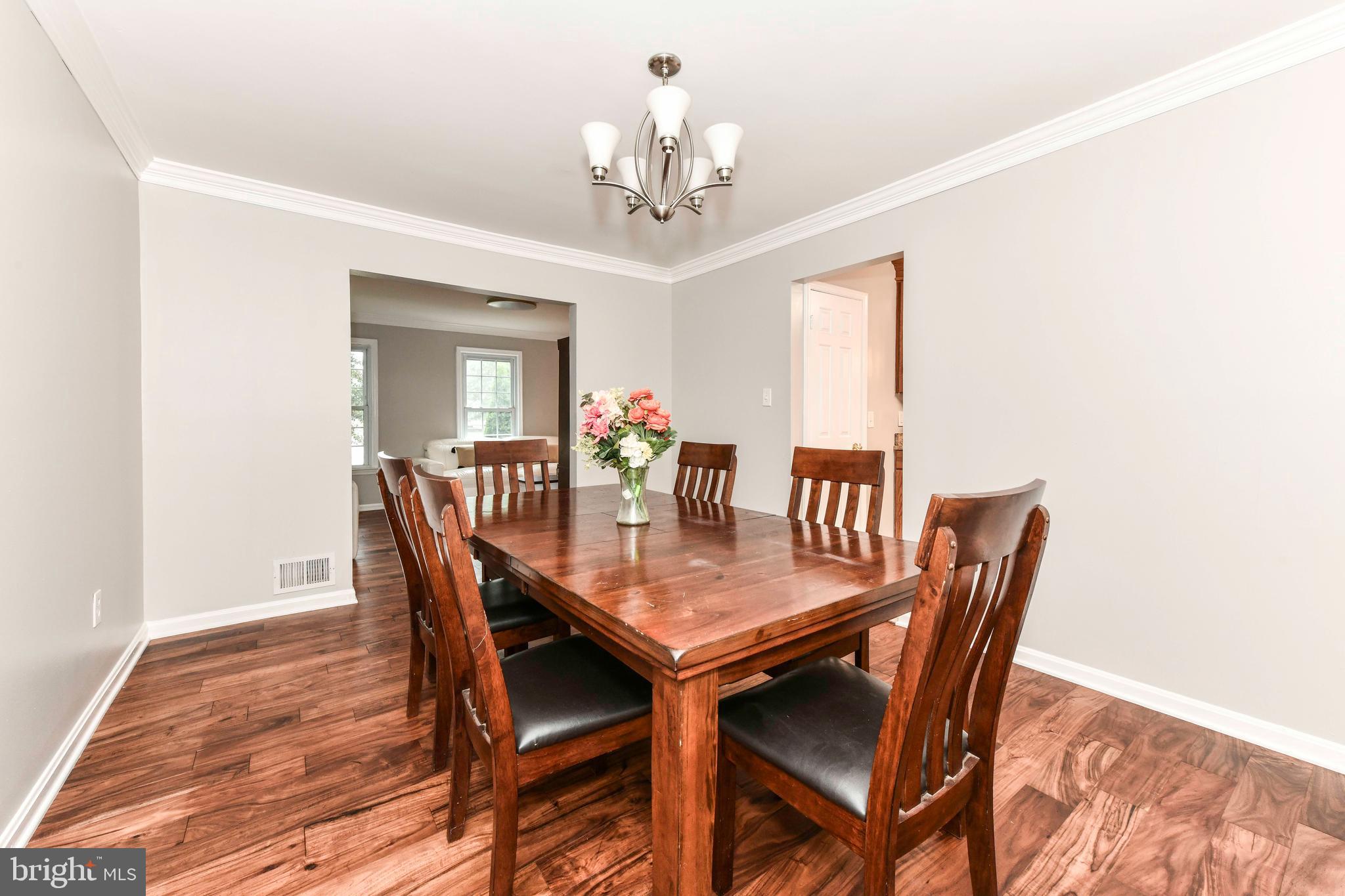 5500 Hampton Forest Way Clifton, VA 20124 - Photo 13 of 49 a dining room with furniture a chandelier and wooden floor