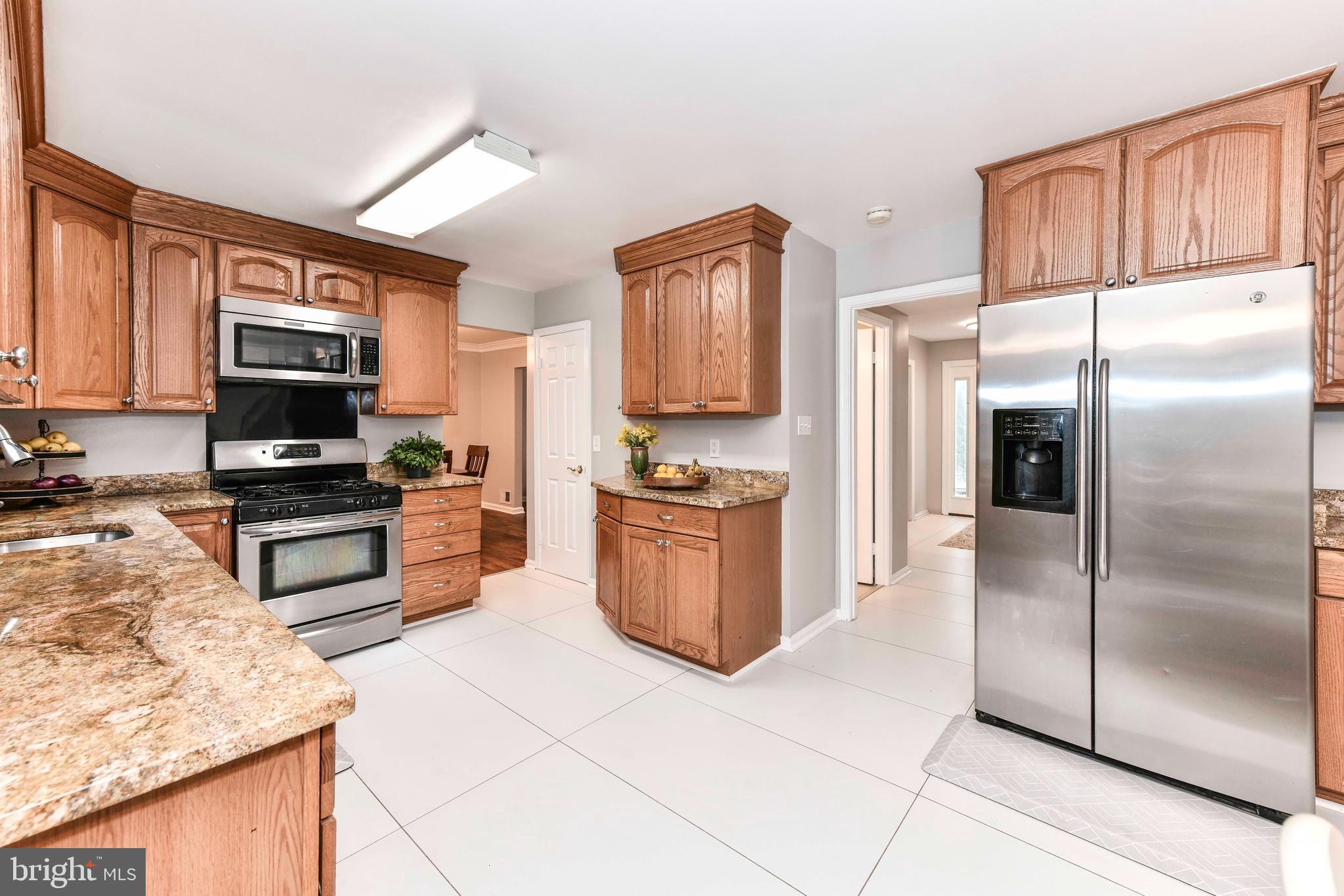5500 Hampton Forest Way Clifton, VA 20124 - Photo 16 of 49 a kitchen with stainless steel appliances granite countertop a refrigerator and a stove top oven
