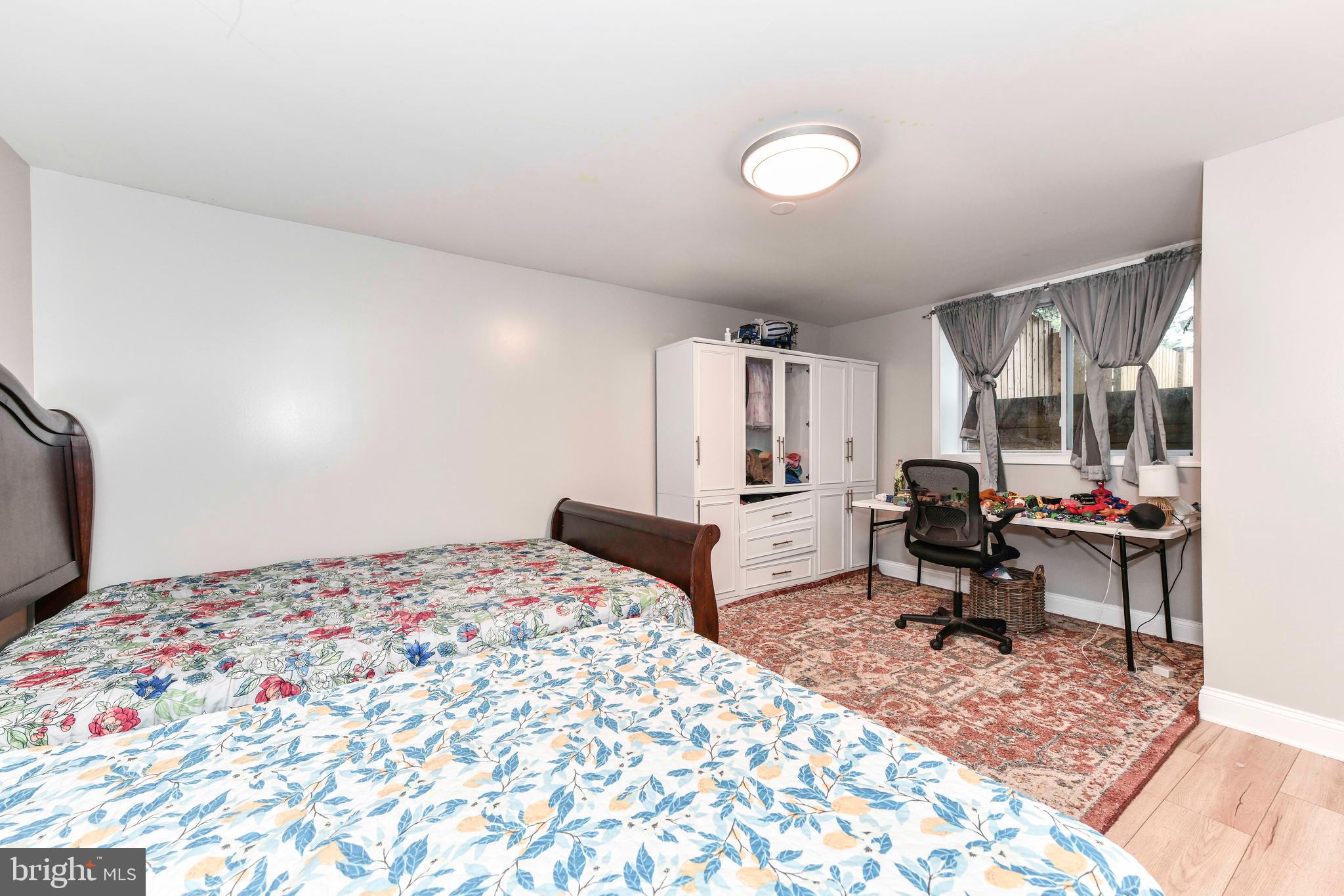 5500 Hampton Forest Way Clifton, VA 20124 - Photo 35 of 49 a bedroom with a bed and wooden floor