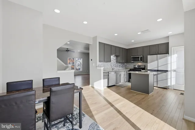 a kitchen with a sink a counter top space stainless steel appliances and cabinets