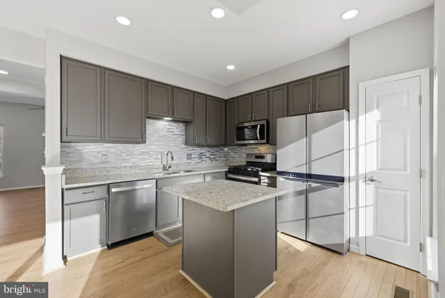 a kitchen with a refrigerator stove and microwave