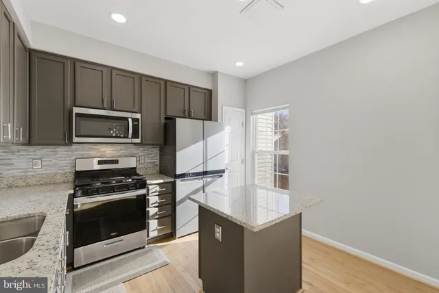 a kitchen with a sink stove and refrigerator