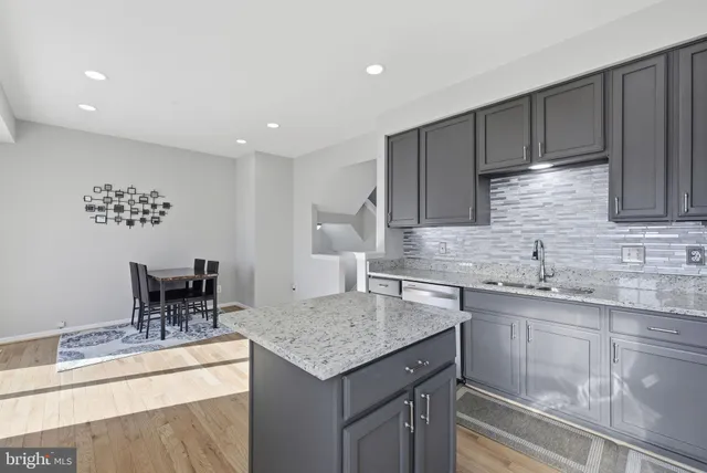 a view of kitchen with granite countertop window and wooden floor