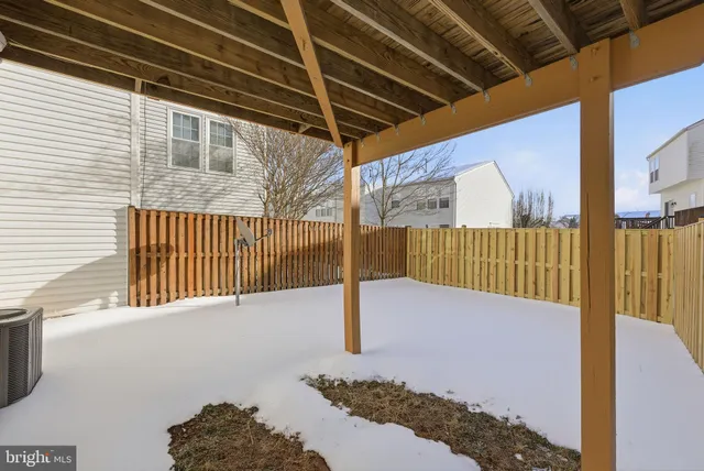 a view of a house with a wooden fence