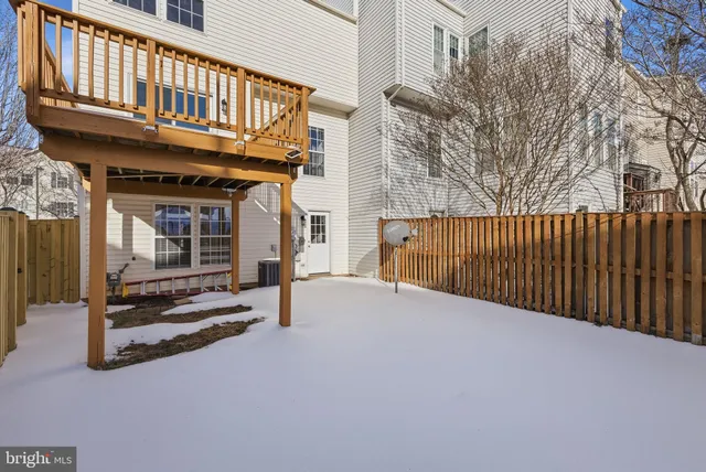 a view of a house with wooden fence