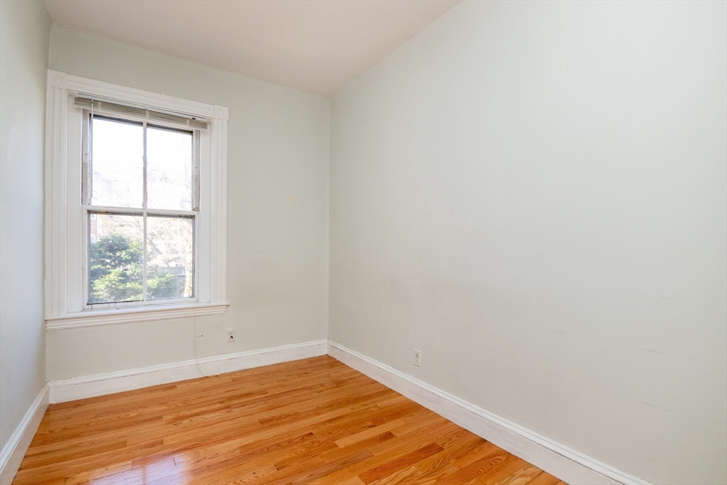 36 Winchester Street, Unit 6 Brookline, MA 02446 - Photo 12 of 20 an empty room with wooden floor and windows
