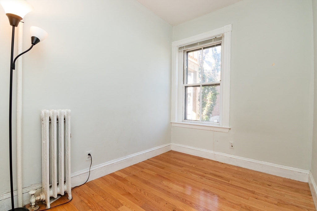 36 Winchester Street, Unit 6 Brookline, MA 02446 - Photo 13 of 20 a room with a window and wooden floor