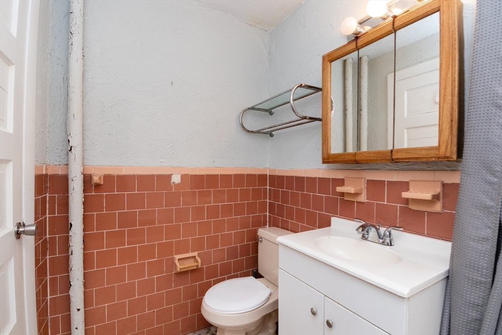 36 Winchester Street, Unit 6 Brookline, MA 02446 - Photo 15 of 20 a bathroom with a sink a toilet and a mirror