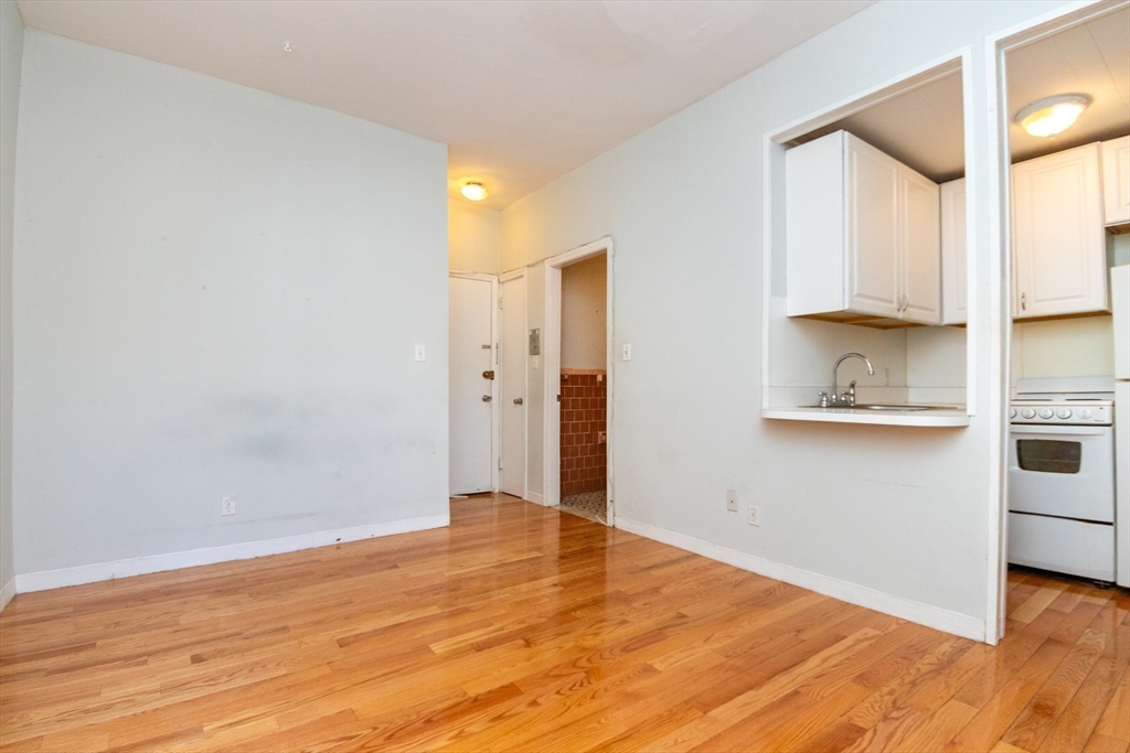 36 Winchester Street, Unit 6 Brookline, MA 02446 - Photo 3 of 20 a view of a kitchen with wooden floor and cabinets