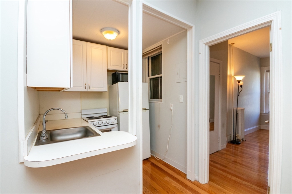 36 Winchester Street, Unit 6 Brookline, MA 02446 - Photo 5 of 20 a kitchen that has a sink and a refrigerator