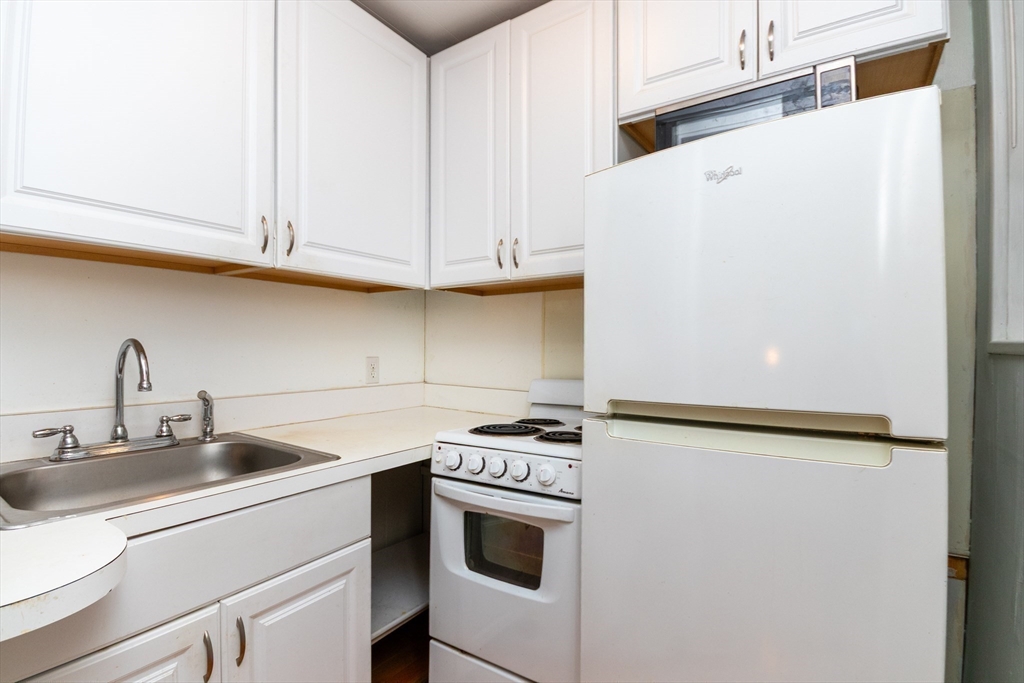 36 Winchester Street, Unit 6 Brookline, MA 02446 - Photo 6 of 20 a kitchen with stainless steel appliances a refrigerator sink and cabinets